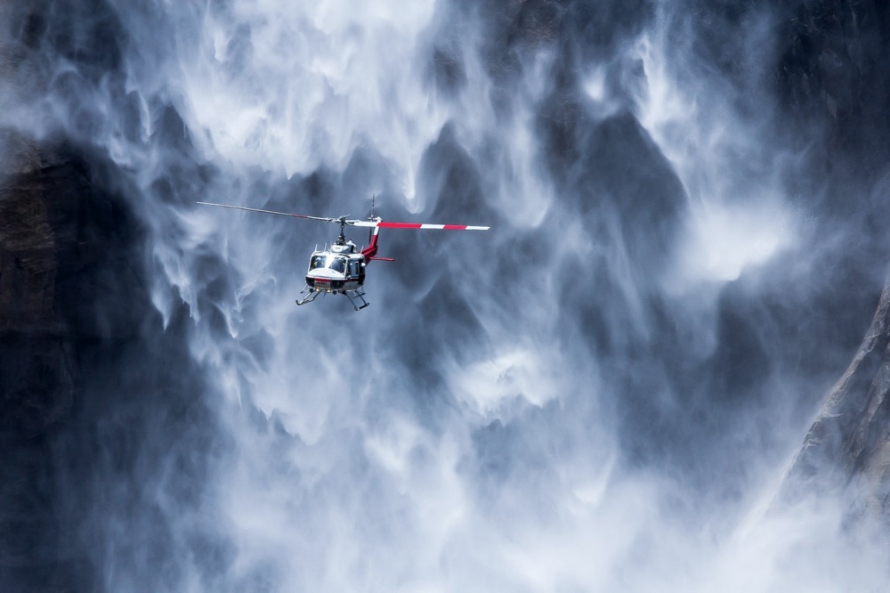 A helicopter near Yosemite waterfall, USA